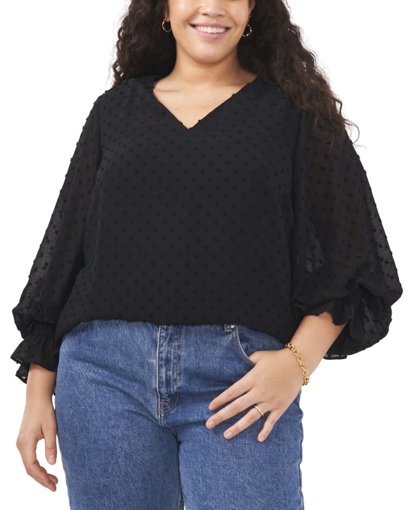 Front of a model wearing a size 1X Harlow Clip Dot Blouse in RICH BLACK by Vince Camuto. | dia_product_style_image_id:261088